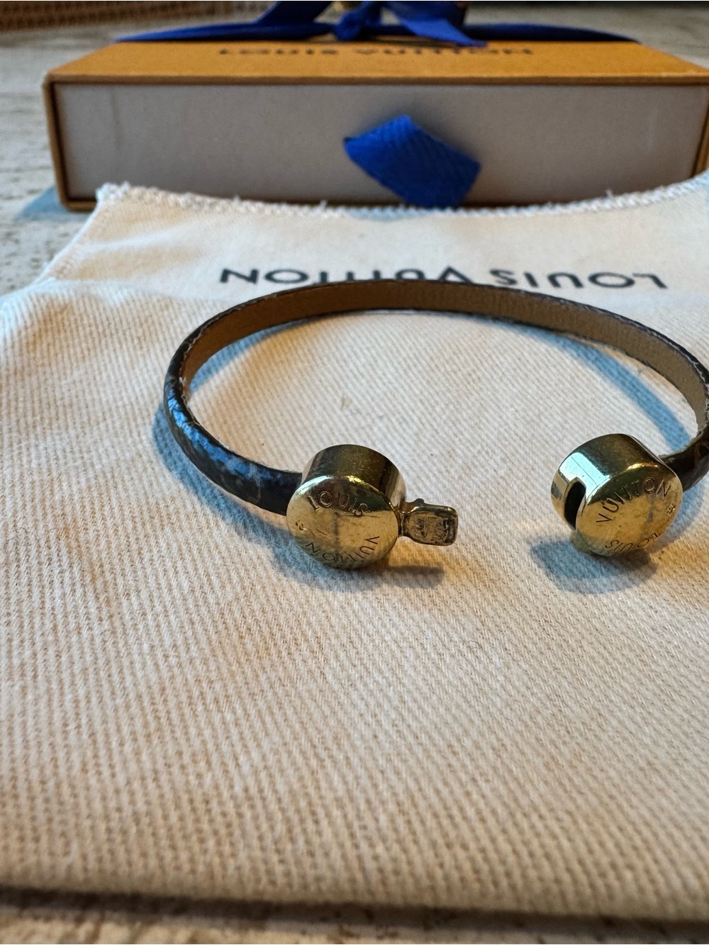 Louis Vuitton signature logo cuff with gold-tone ends